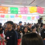 Group of people in Building 700 South celebrating La Bienvenida