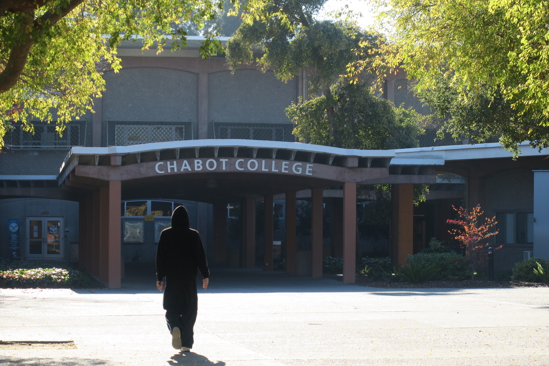 Student walking towards Chabot College's entrance